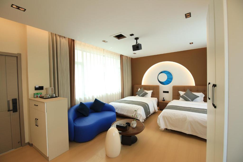 Postel nebo postele na pokoji v ubytování Dali Yufu B&B Hotel