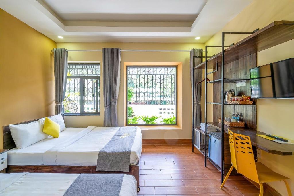 Postel nebo postele na pokoji v ubytování Richy Dalat Hotel