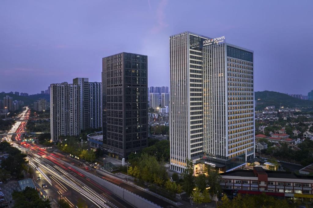 a city with tall skyscrapers and a highway at Four Points by Sheraton Chongqing North Railway Station in Chongqing