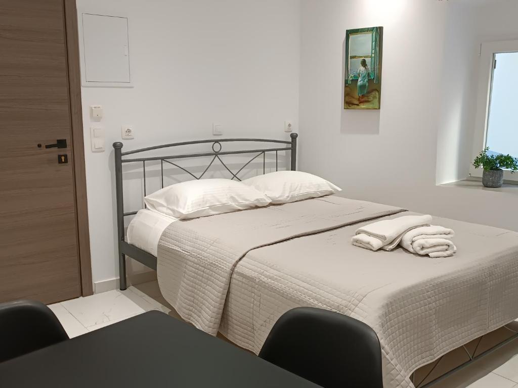 a bedroom with a bed with two towels on it at Tatiana's Town Studio in Corfu