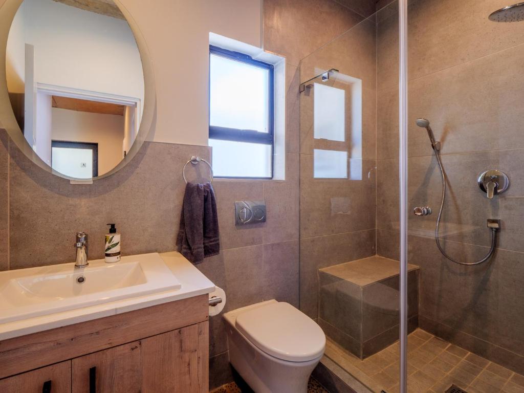 a bathroom with a sink toilet and a shower at The Lofts on Manaar in Durban