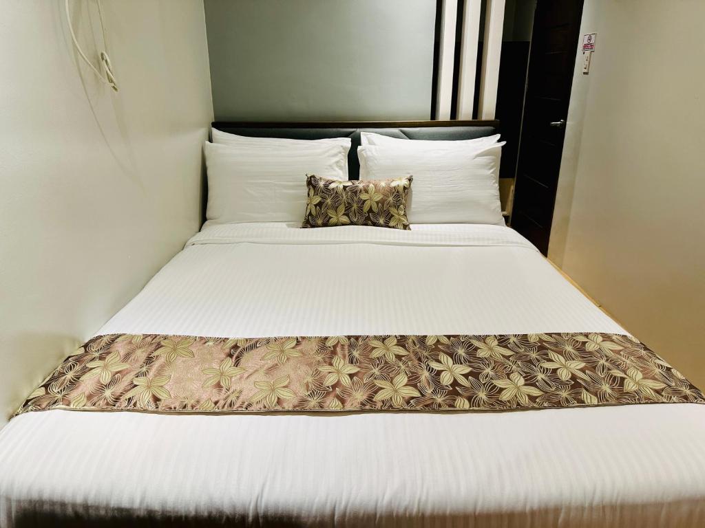 Postel nebo postele na pokoji v ubytování Buenaventura Suites