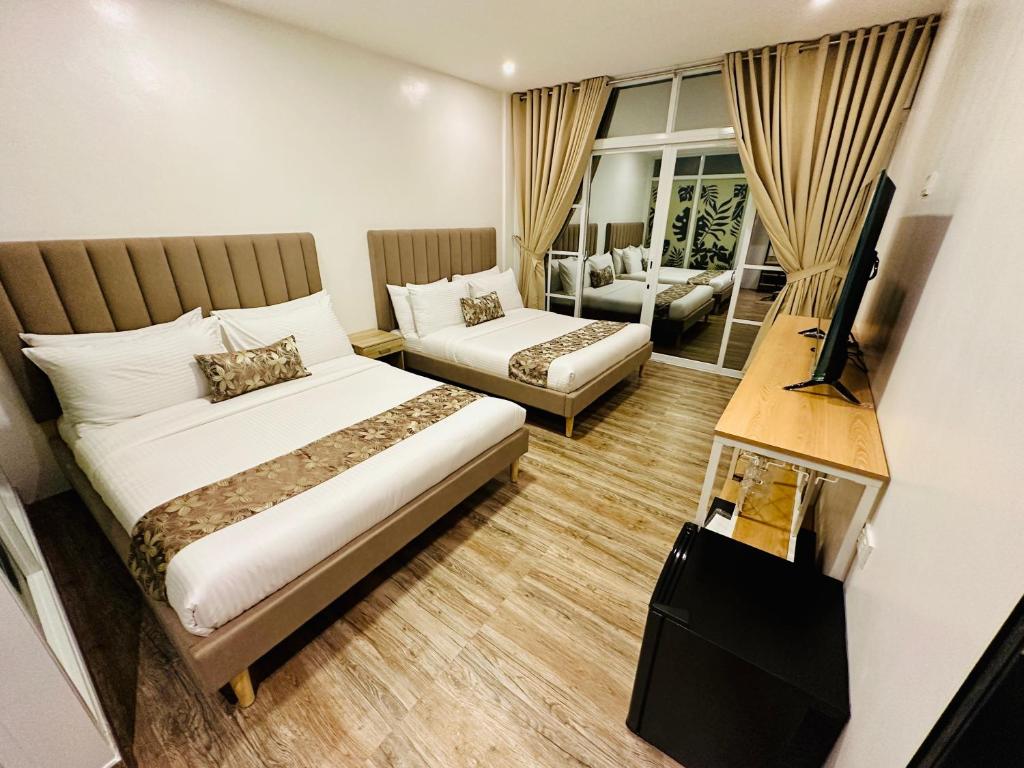 Postel nebo postele na pokoji v ubytování Buenaventura Suites