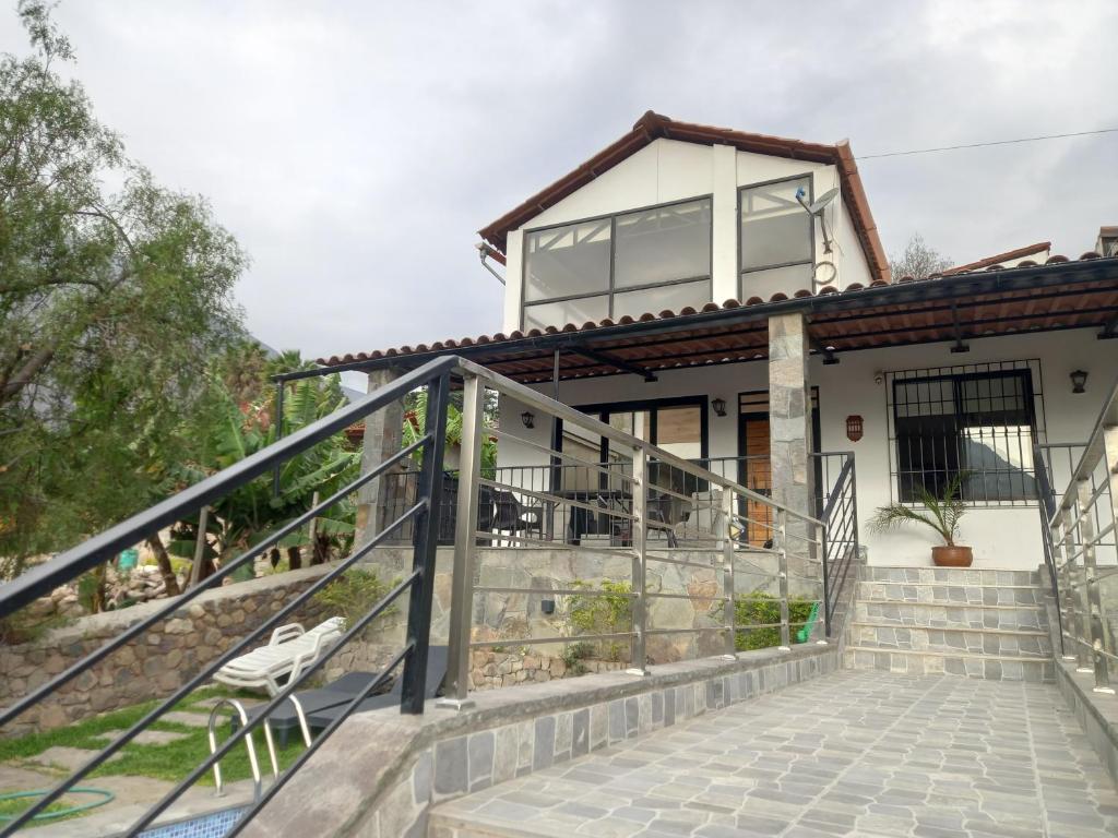 a house with a staircase leading up to it at CASA DE CAMPO CON PISCINA EN COCACHACRA HUAROCHIRI SOL TODO EL AÑo in Cocachacra