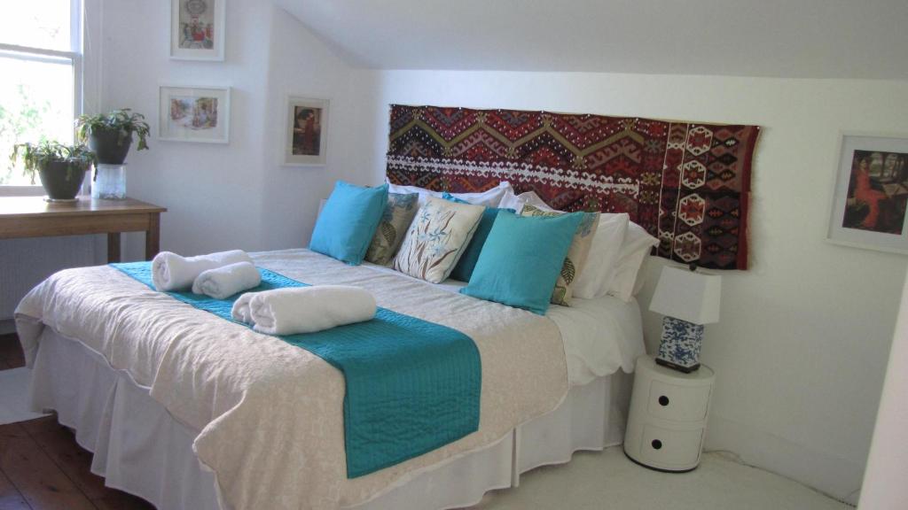 a bedroom with a large bed with towels on it at Holmewood Homestay in London