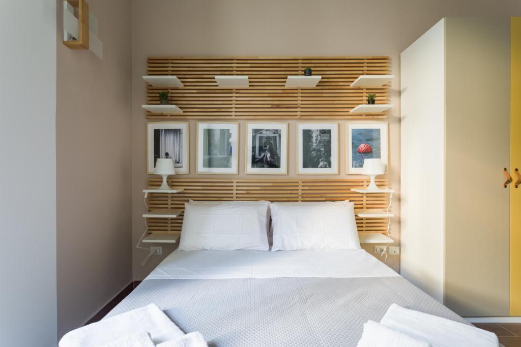 a bedroom with a white bed and some windows at Casa Papaccio Apartment & Spa By Dimorra in Naples