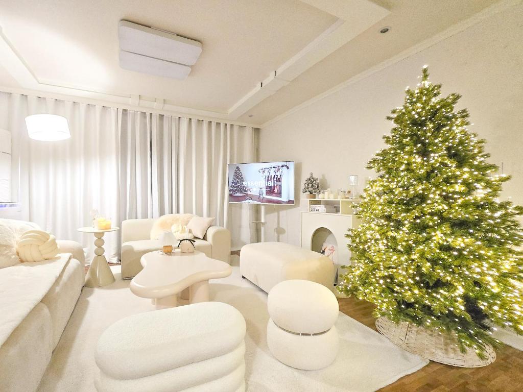 a living room with a christmas tree and a couch at Yeon Stay in Seoul