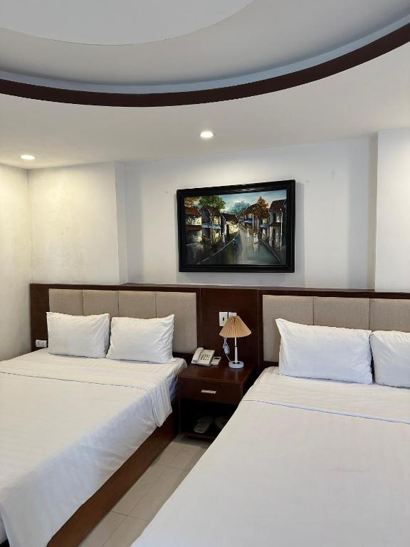 Postel nebo postele na pokoji v ubytování New Era Hotel & Apartments