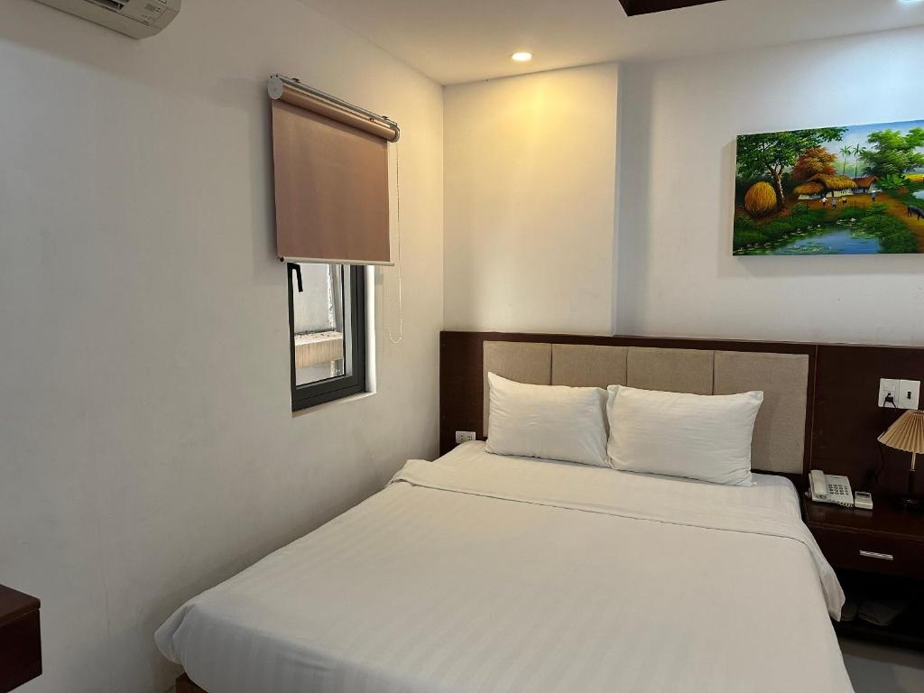 Postel nebo postele na pokoji v ubytování New Era Hotel & Apartments