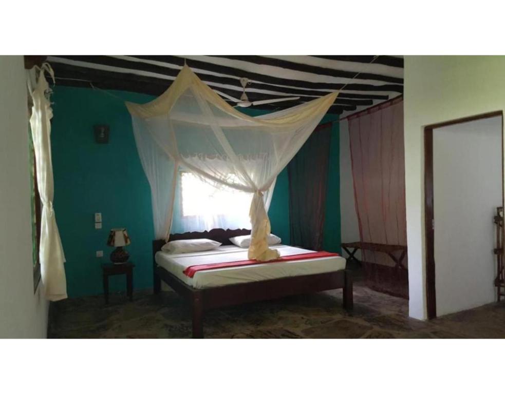 Postel nebo postele na pokoji v ubytování Watamu Eco Villas