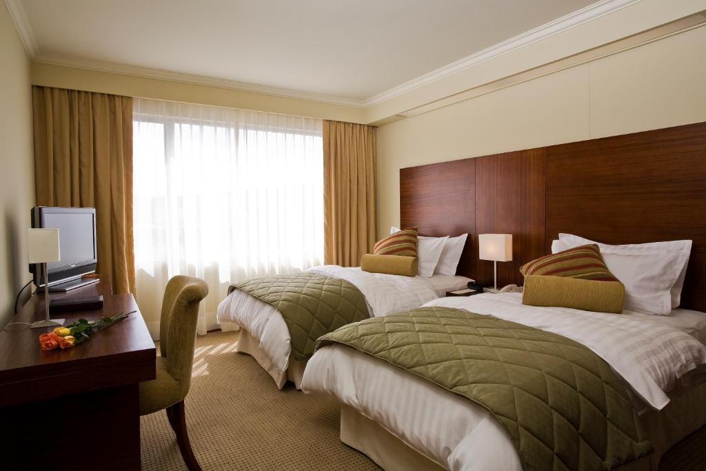 Postel nebo postele na pokoji v ubytování Hotel Stubel Suites & Cafe