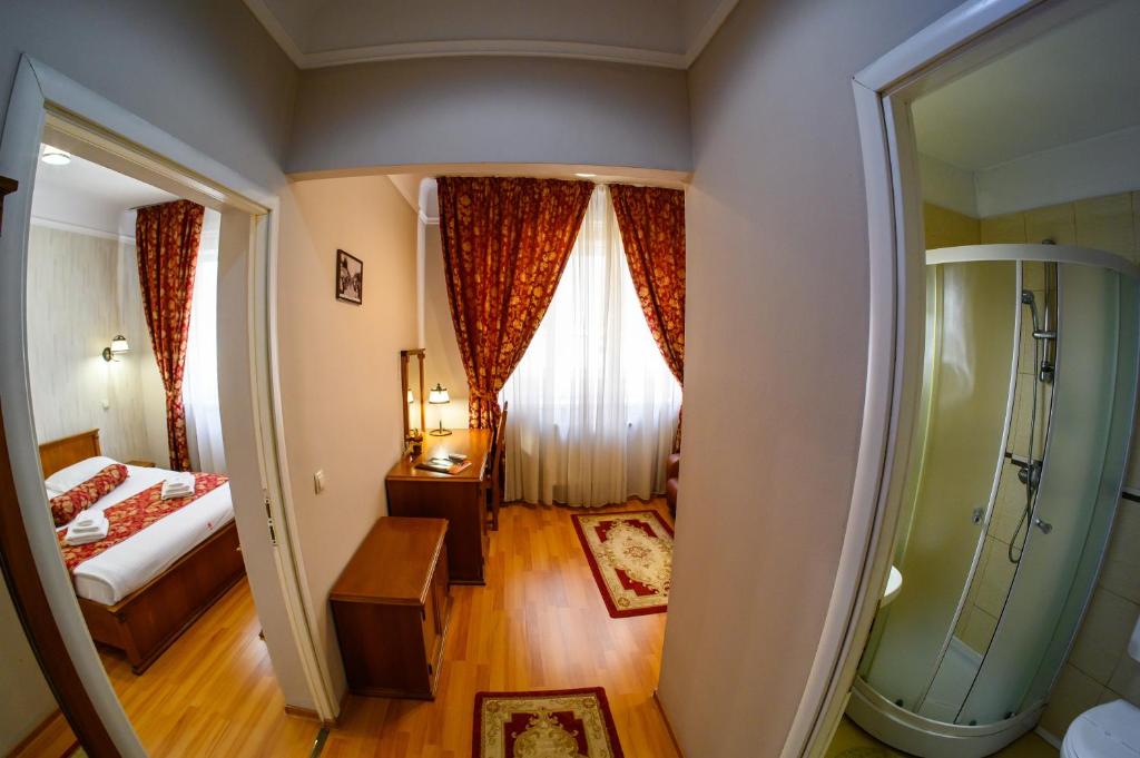 a hotel room with a bed and a window at Hotel Transilvania in Cluj-Napoca