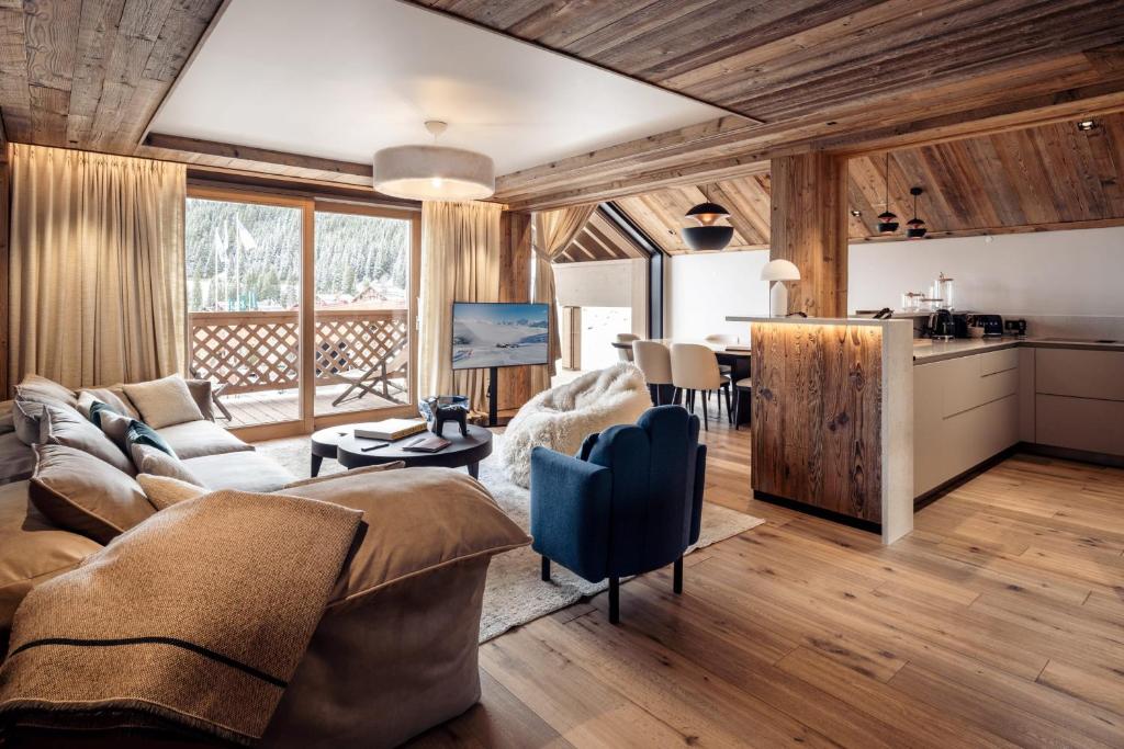 a living room with a couch and a table at Antarès SIRIUS 301- Spacious ski inski out apartment in Méribel