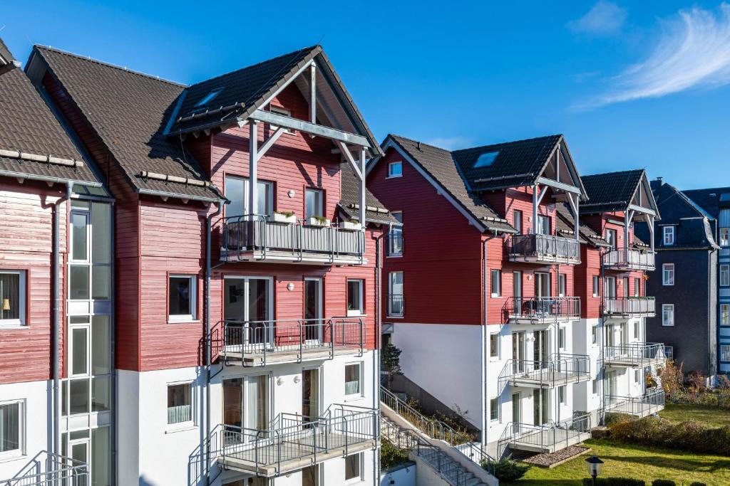 a row of red and white houses at Ferienwohnung Tannenblick 2-1 in Oberhof