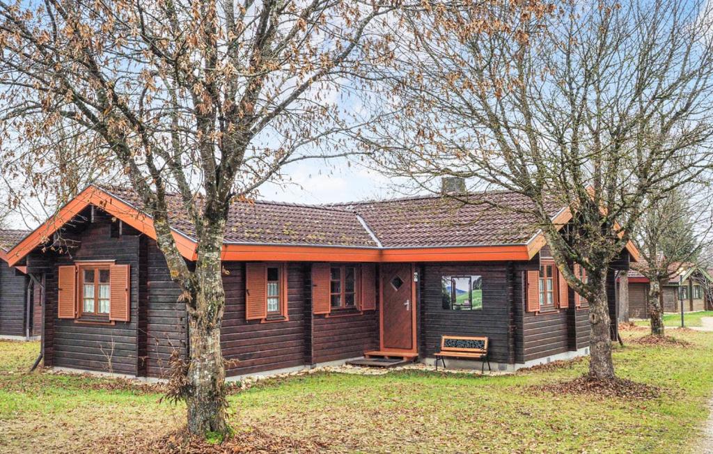 a wooden house with two trees in front of it at Ferienhaus Neckar 70 in Hayingen