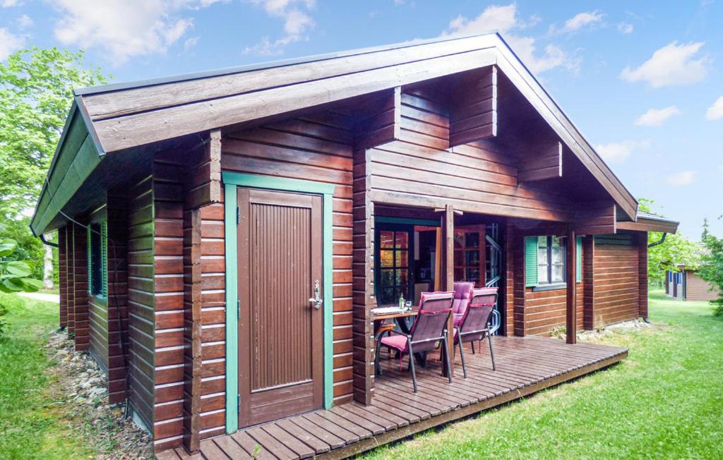 eine Holzhütte mit Stühlen und einem Tisch auf einer Terrasse in der Unterkunft Ferienhaus Neckar 7 in Hayingen