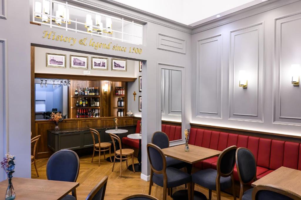 a restaurant with tables and chairs and a bar at Hotel Transilvania in Cluj-Napoca