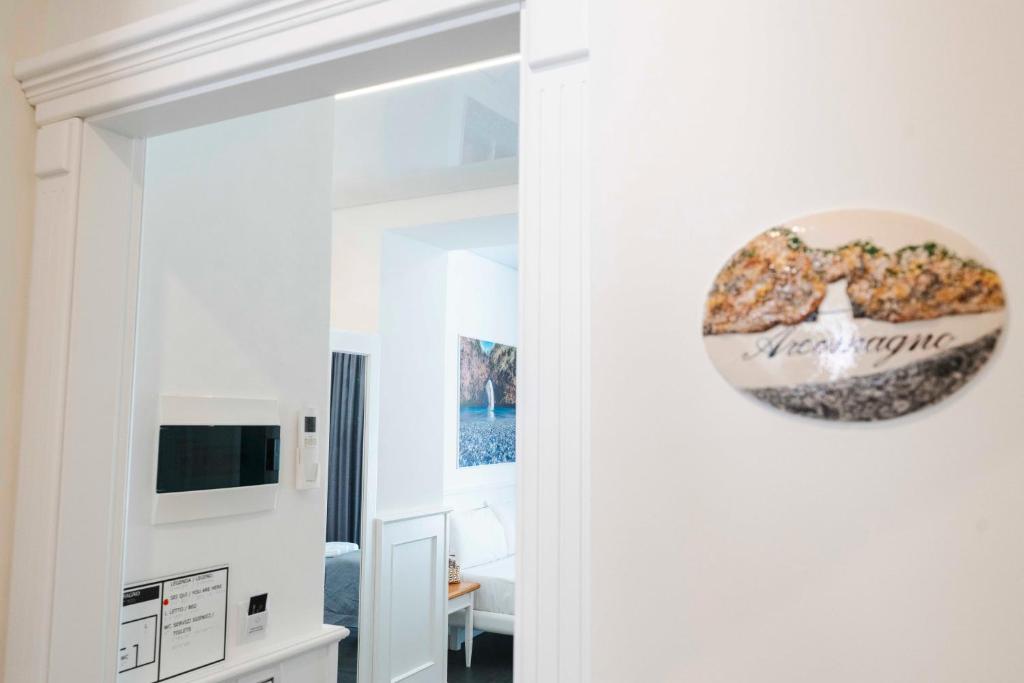 a living room with a mirror and a tv at TEA Luxury - Praia a Mare in Praia a Mare