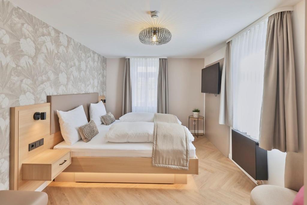 Postel nebo postele na pokoji v ubytování Hotel Württemberger Hof