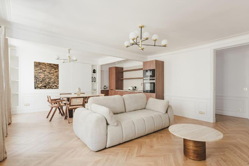 un salon avec un canapé blanc et une table dans l'établissement Appartement de Luxe 6P - Muette Trocadero, à Paris