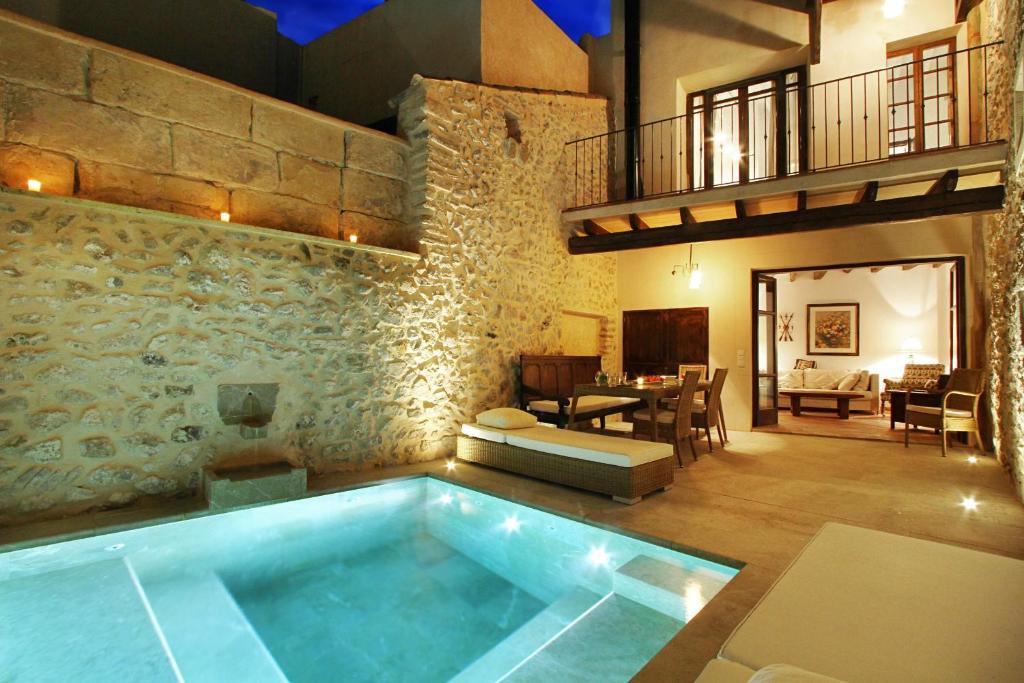 a pool in the middle of a room with a living room at Mallorca One in Pollença