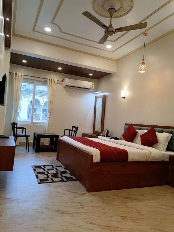 a bedroom with a large bed and a ceiling at Happy Home Paying Guest House in Varanasi