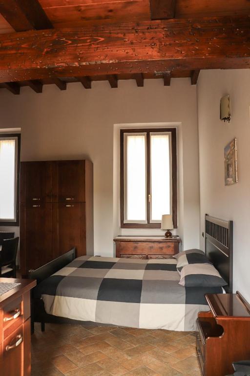 Postel nebo postele na pokoji v ubytování La Corte di Brusuglio Apartments
