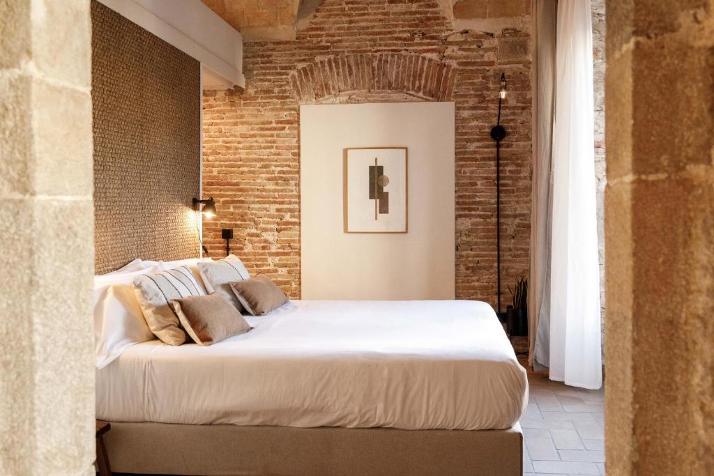 Postel nebo postele na pokoji v ubytování La Comuna by Bon Dia Residences
