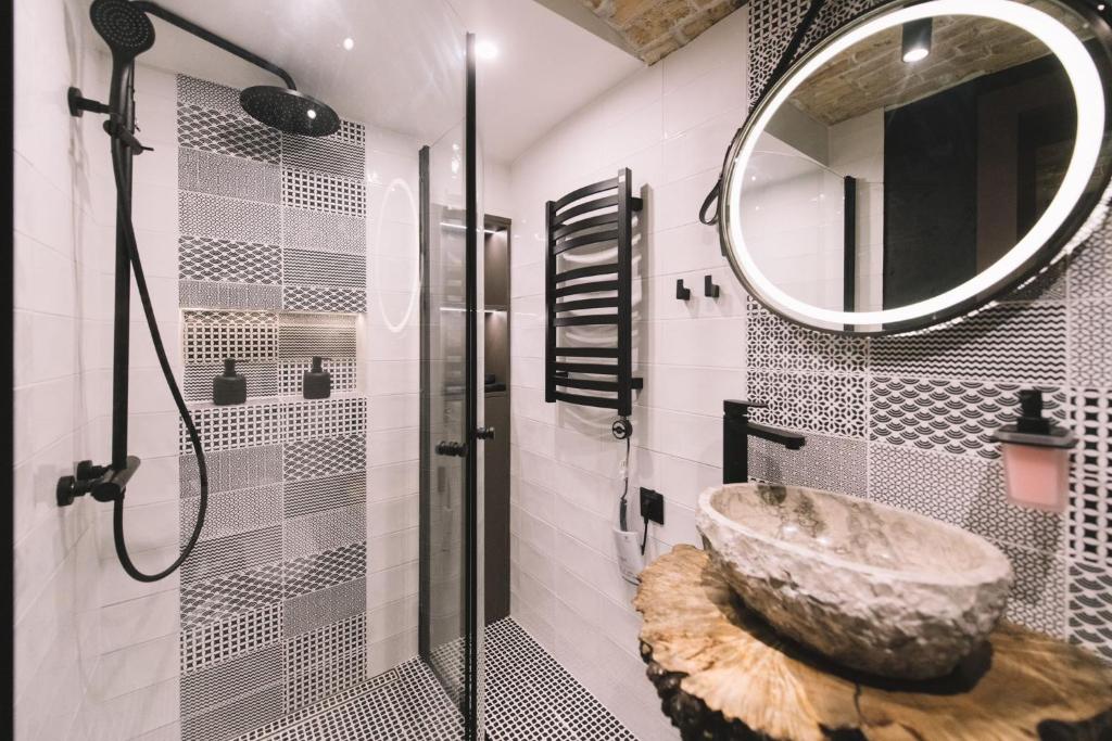 a bathroom with a large stone sink and a mirror at Photographer Rudolf's Studio - ground floor with separate entrance in Rīga