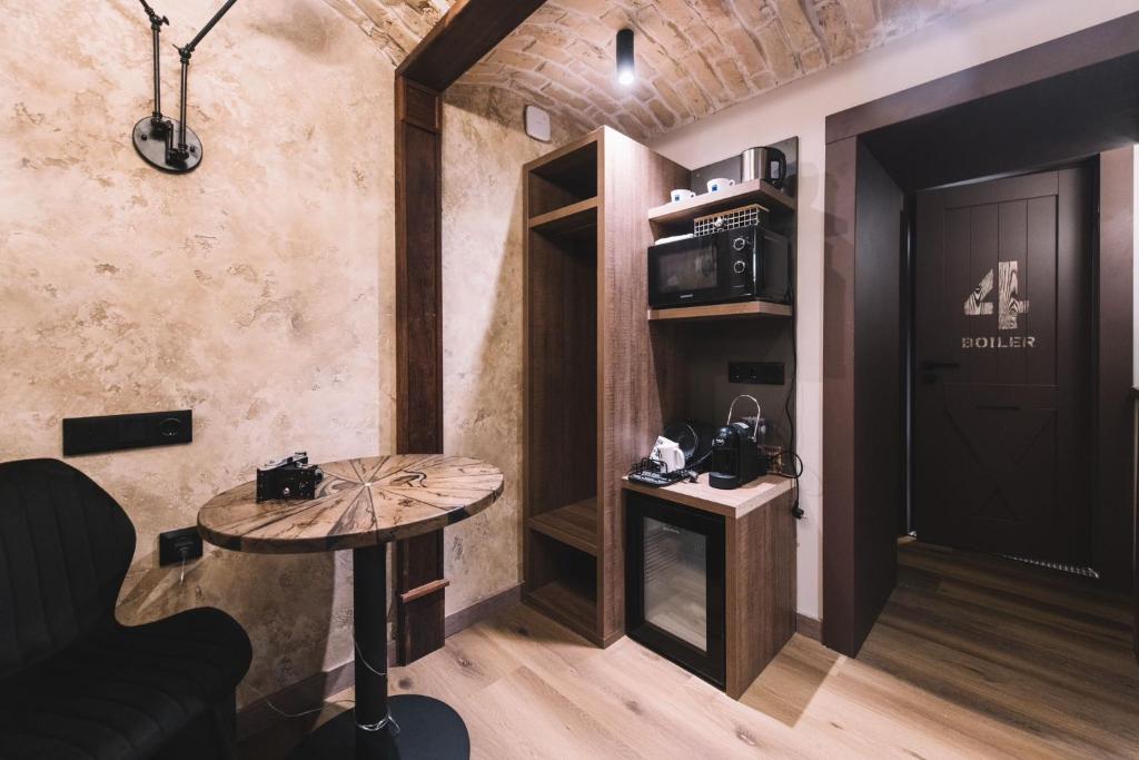 a room with a table and a room with a door at Photographer Rudolf's Studio - ground floor with separate entrance in Rīga