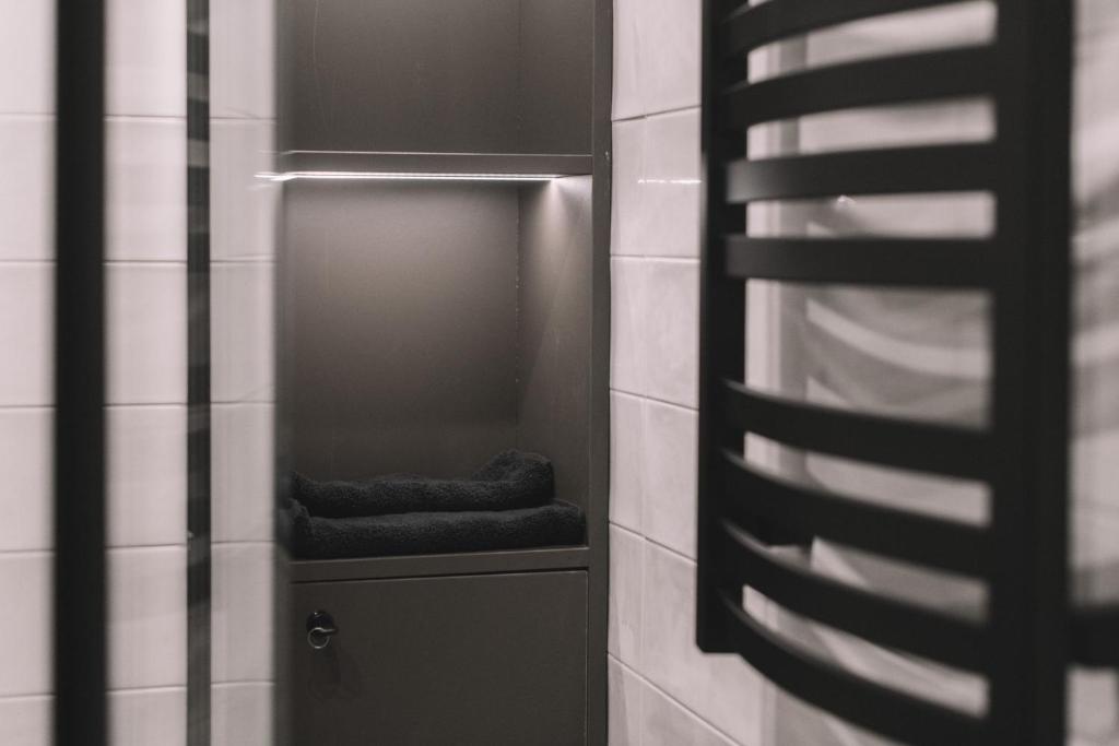 a closet with two folded towels in a bathroom at Photographer Rudolf's Studio - ground floor with separate entrance in Rīga