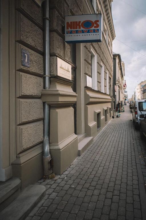 a building with a sign on the side of a street at Photographer Rudolf's Studio - ground floor with separate entrance in Rīga