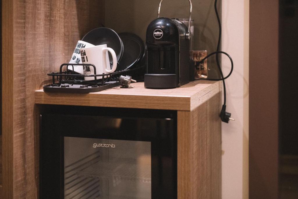 a microwave sitting on top of a wooden table at Photographer Rudolf's Studio - ground floor with separate entrance in Rīga