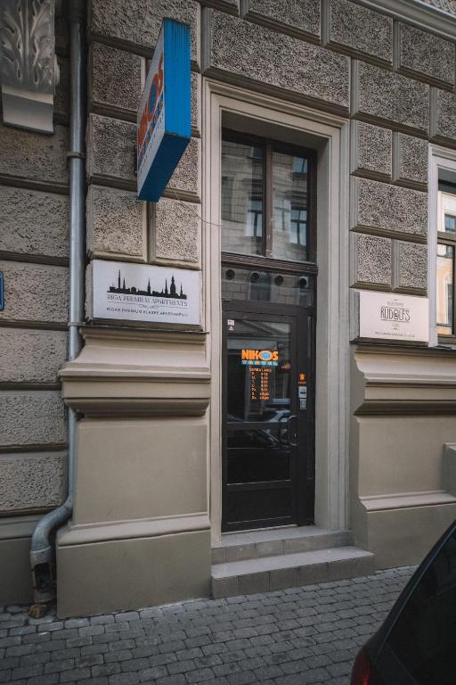 a building with a door with a sign on it at Photographer Rudolf's Studio - ground floor with separate entrance in Rīga