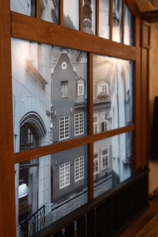 a window with a view of a building through it at Photographer Rudolf's Studio - ground floor with separate entrance in Rīga