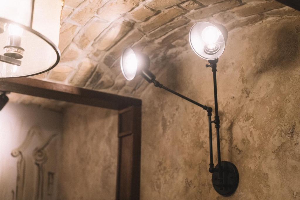 two lights on a wall in a room at Photographer Rudolf's Studio - ground floor with separate entrance in Rīga