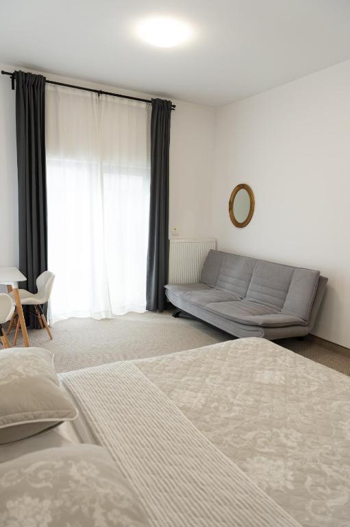 a living room with two beds and a couch at Complex Pescăresc Gura Repezii Borșa in Borşa