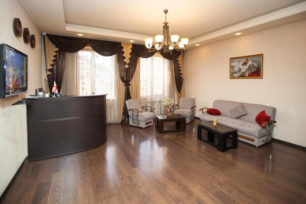 a living room with a couch and a table at Hotel 4You in Tbilisi City