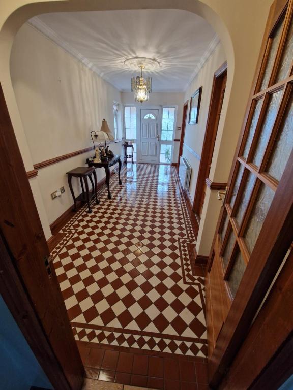 a hallway with a checkered floor in a house at Woodview in Glenville