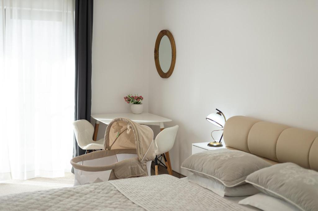 a bedroom with a bed and a table and a mirror at Complex Pescăresc Gura Repezii Borșa in Borşa