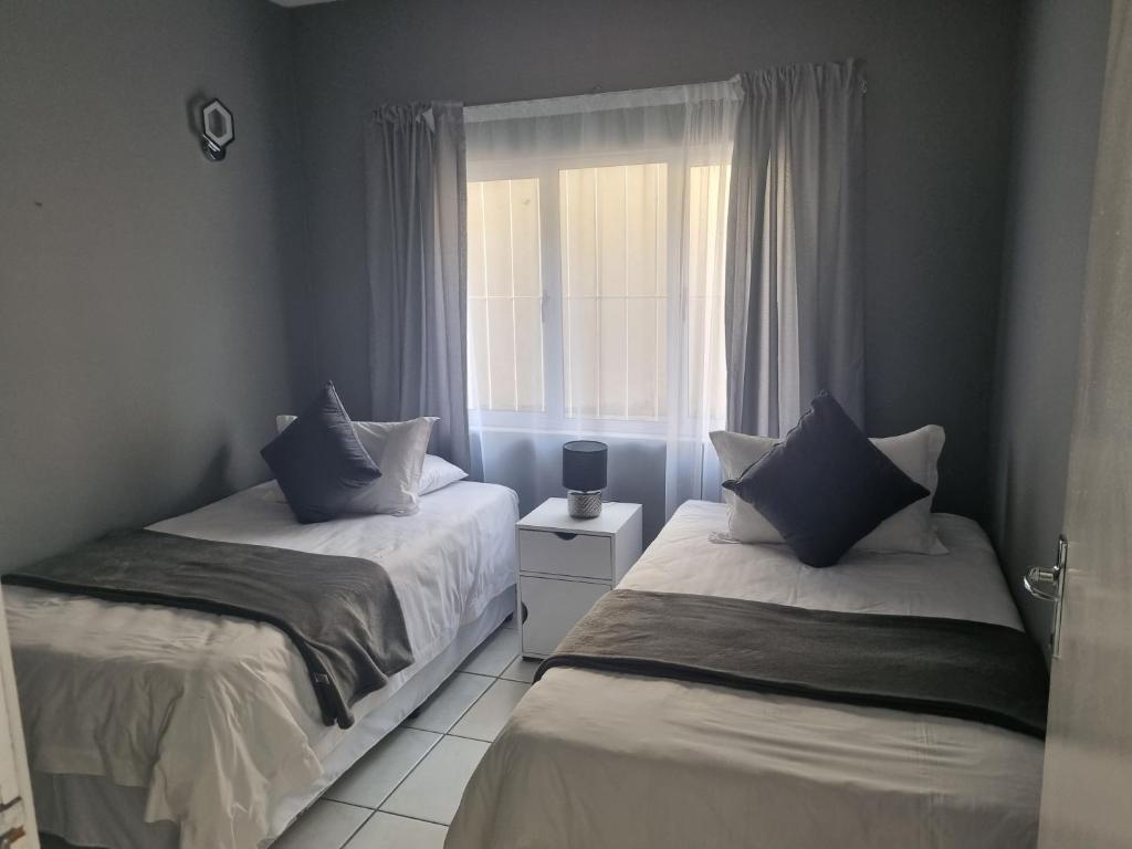 Postel nebo postele na pokoji v ubytování Ingwe Manor Guesthouse