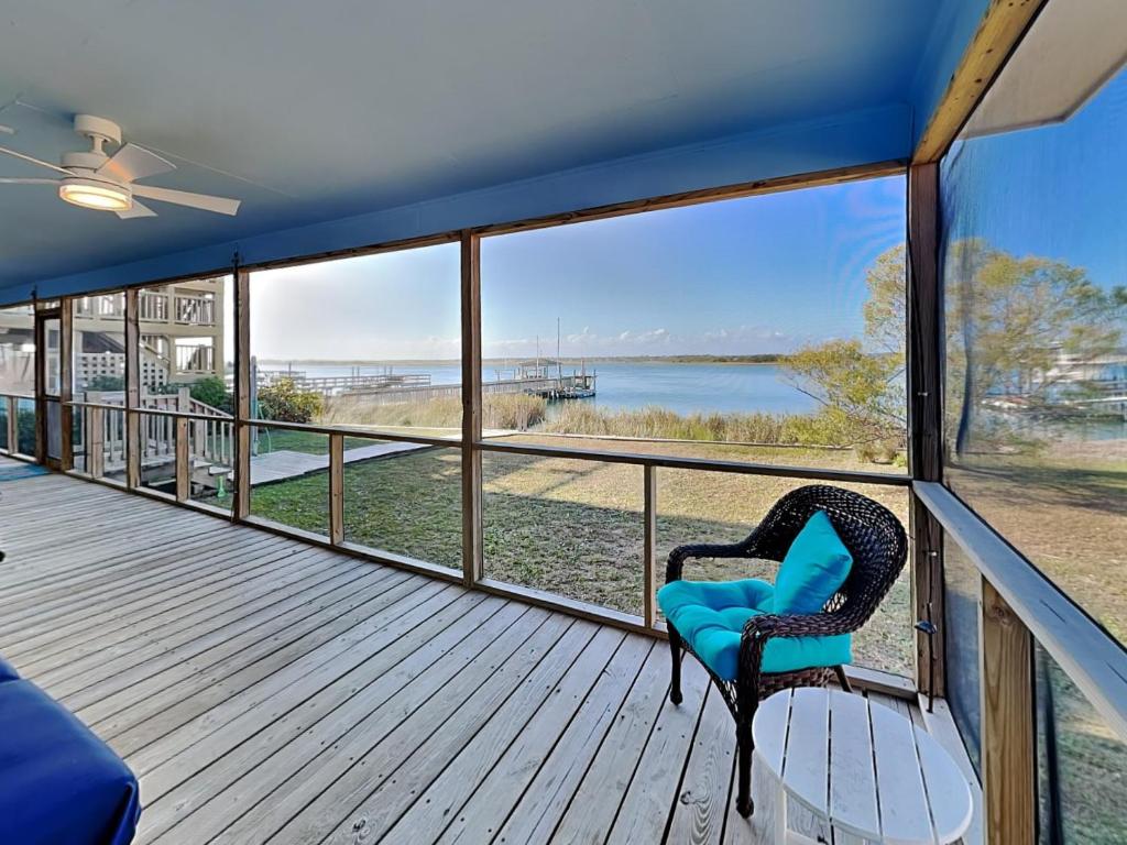 a balcony with a chair and a view of the water at Whitaker Sea La Vie in Surf City