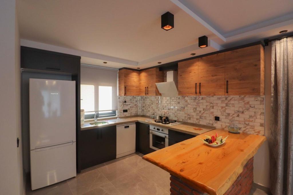 a kitchen with wooden cabinets and a wooden counter top at Adrasan Villa Adrasya in Olympos