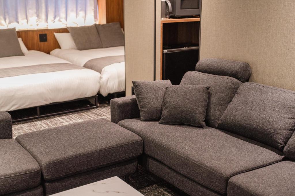 Postel nebo postele na pokoji v ubytování The LOFT INN HAKATA