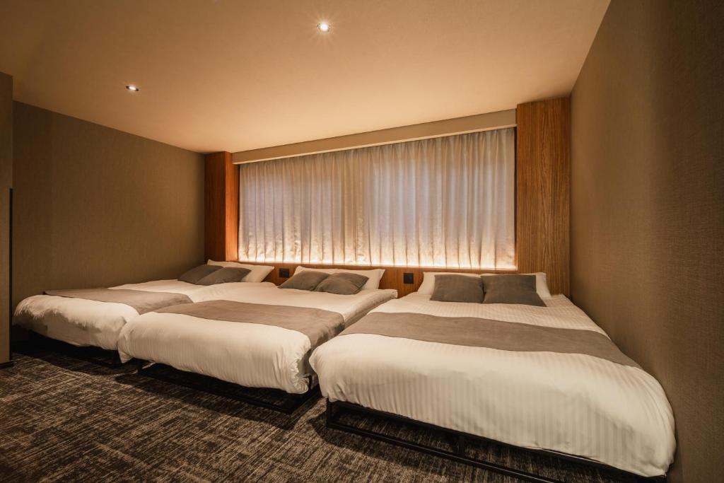 Postel nebo postele na pokoji v ubytování The LOFT INN HAKATA