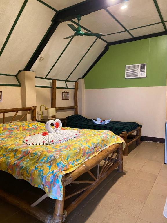 Postel nebo postele na pokoji v ubytování Ravenala Beach Bungalows