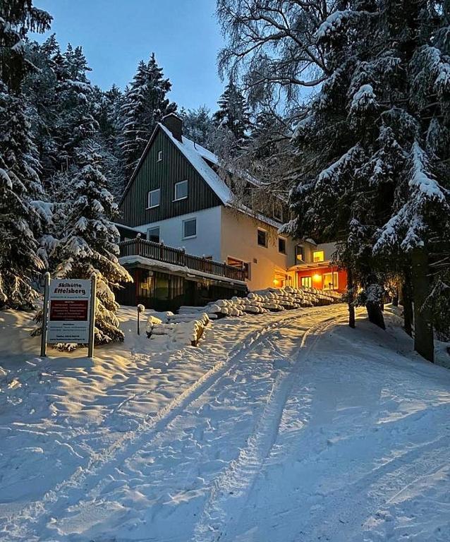 a snow covered road in front of a building at Skihütte Ettelsberg in Willingen