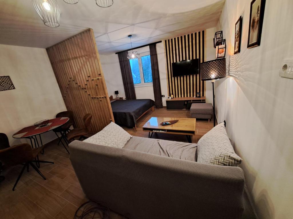 a living room with a couch and a table at Twin mountain in Kopaonik