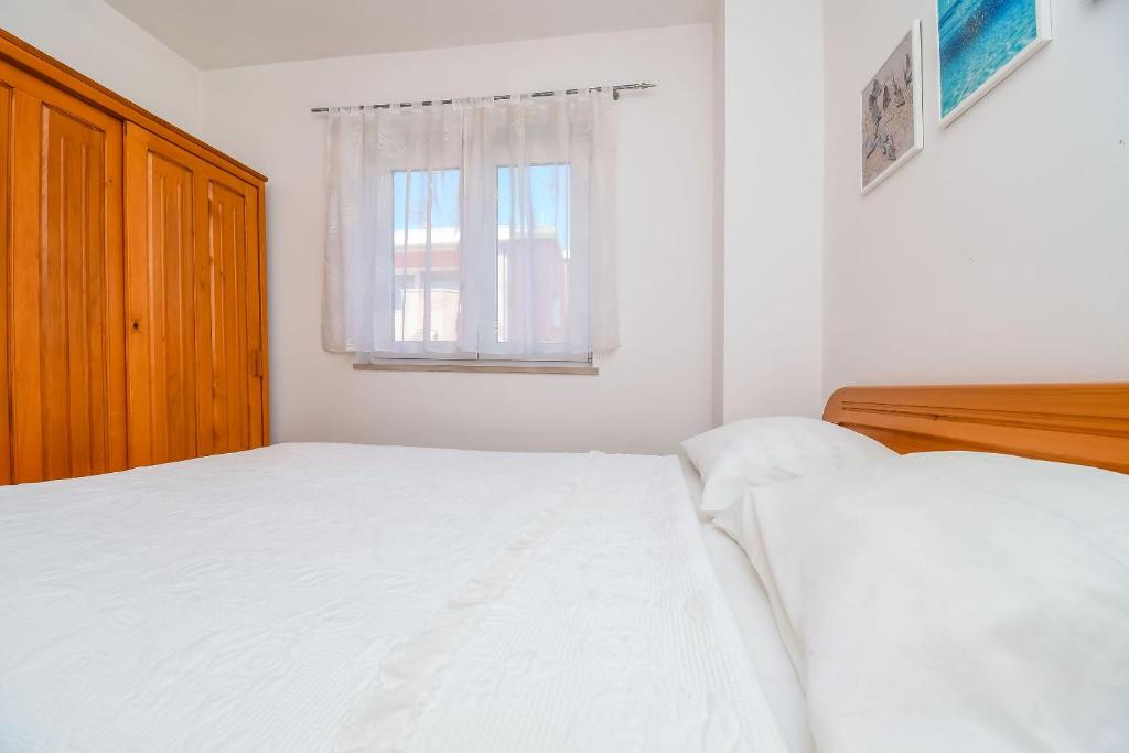 Postel nebo postele na pokoji v ubytování Apartments Tina