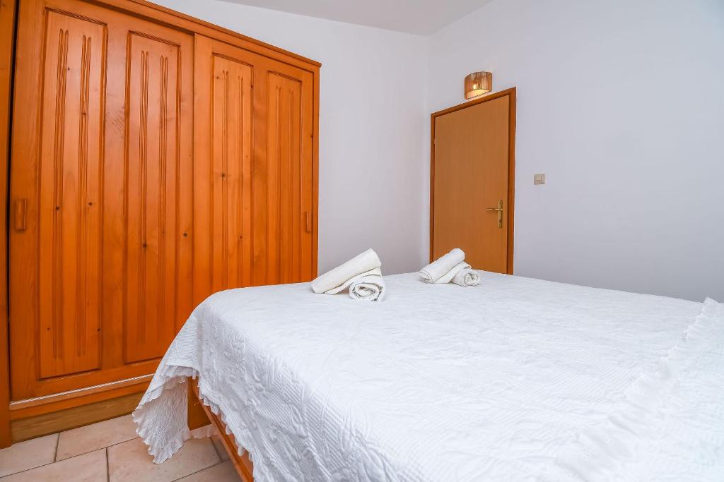 Postel nebo postele na pokoji v ubytování Apartments Tina